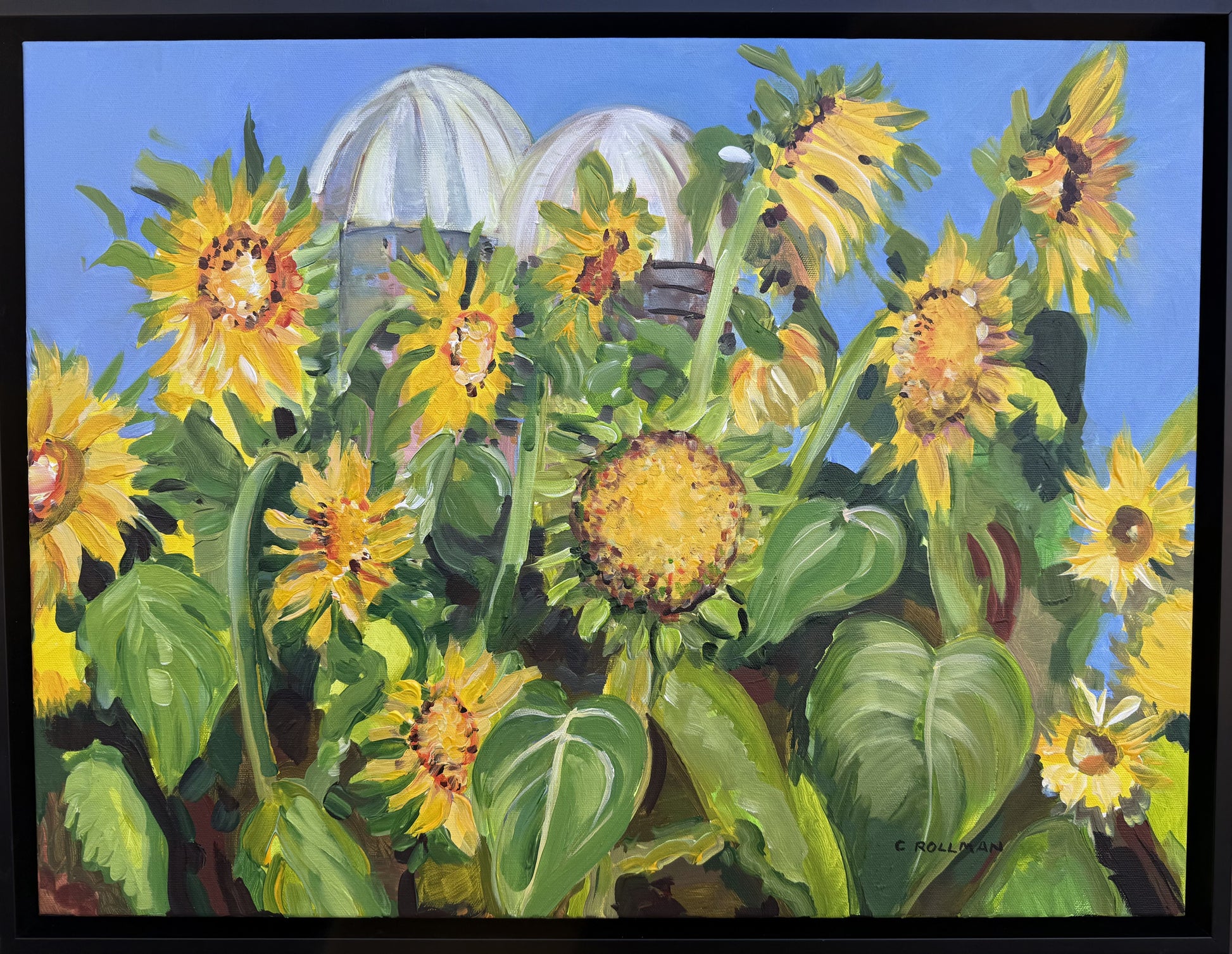 Painting of sunflowers with silos in the background. Framed, acrylic.